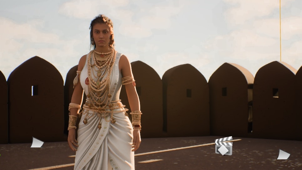 Queen Somalladevi in white drape and layered ornament on a rampart