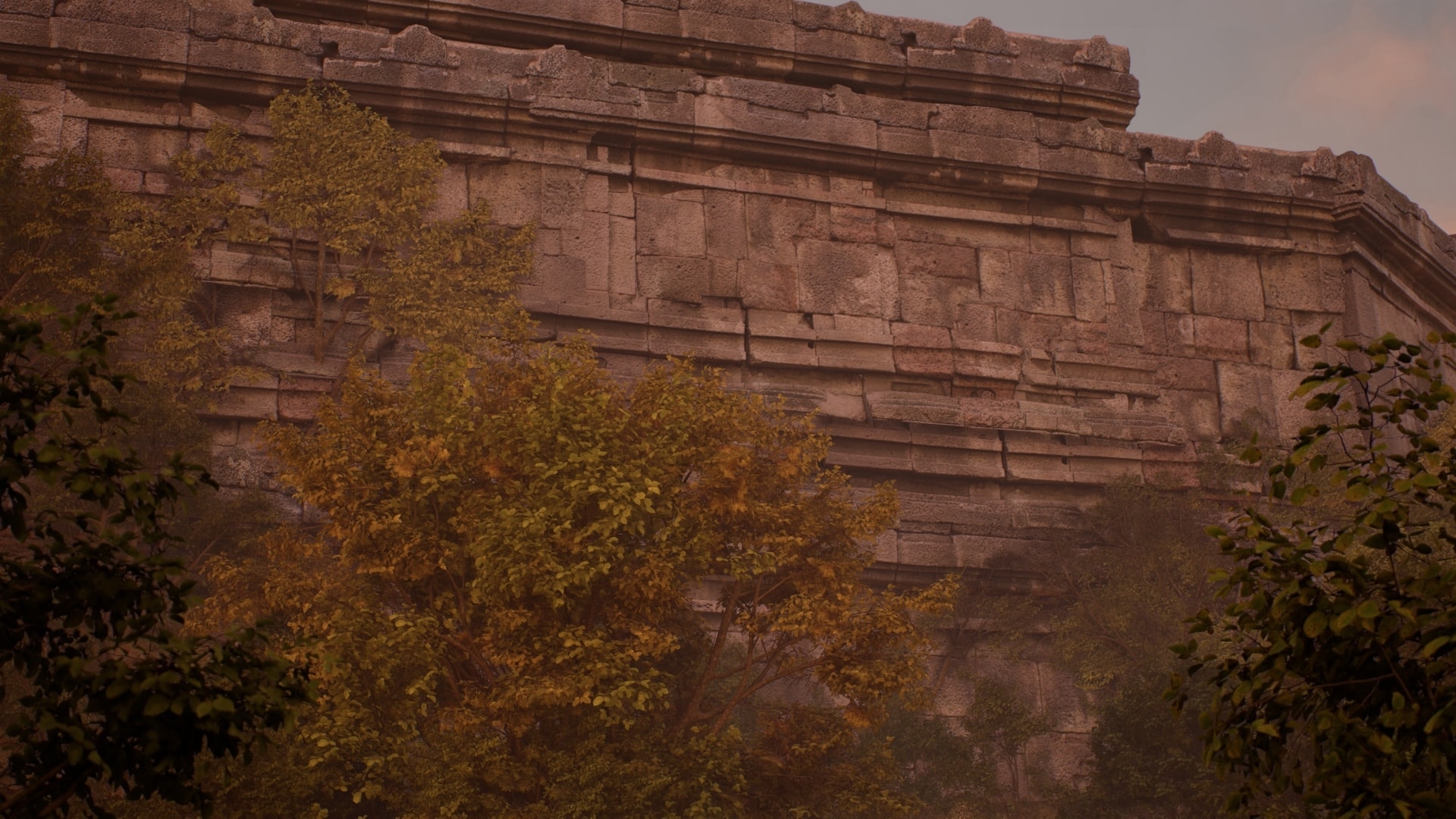 A coursed stone revetment wall rising above trees in haze